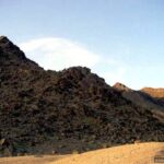 Dark volcanic mountains at golden hour, Death Valley